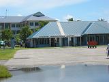 tuv03 The Funafuti International Airport welcomes two scheduled flights per week, and a few hundreds visitors per year, most of them on some official business of one sort or another. In between flights, the runway serves as a normal road.