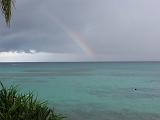 tuv08 .... and finally with a wide rainbow to the west. With a diameter of close to 20km, the lagoon has a continuous strip of solid land only to the east. On the other three sides, only a few islets (motu's) are scattered along a wide arch.